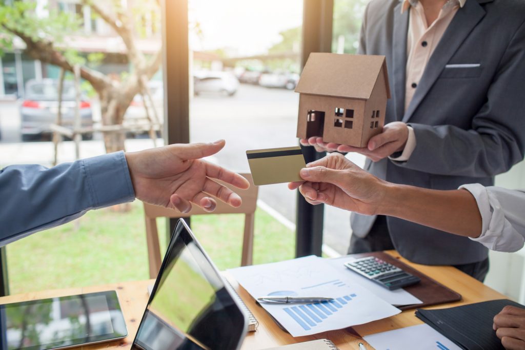 Hands of men who are submitting credit cards to customers, the concept of home loan with credit.